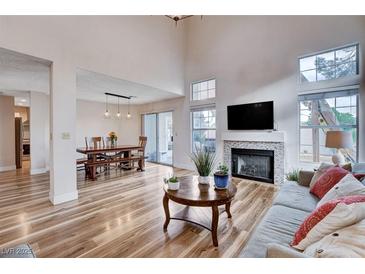 Inviting living room boasts wood floors, fireplace, and ample natural light at 2504 Cove Rd, Las Vegas, NV 89128