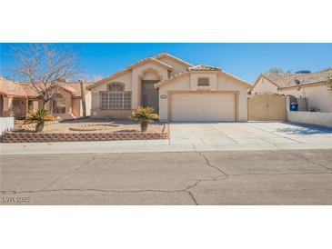 Inviting single-story home with a well-manicured yard and charming desert landscaping at 4032 Rustic Oak Ct, North Las Vegas, NV 89032