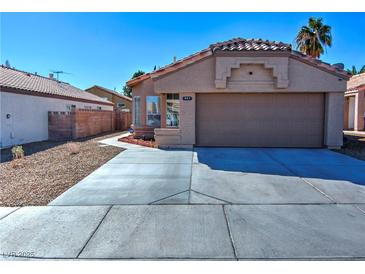 Charming single-story home featuring a well-maintained front yard and a two-car garage at 951 Carnival Ave, Las Vegas, NV 89123