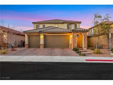 Charming two-story home boasts a well-manicured lawn and three-car garage at 10184 Fire Skye Ave, Las Vegas, NV 89166