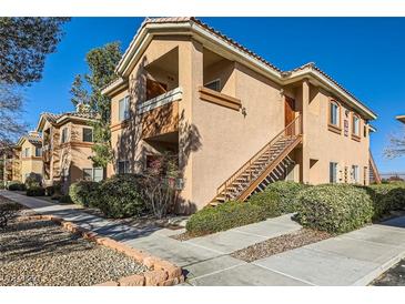 Exterior view of the condo building with stairs leading to the front door and well-maintained landscaping at 1050 E Cactus Ave # 1049, Las Vegas, NV 89183