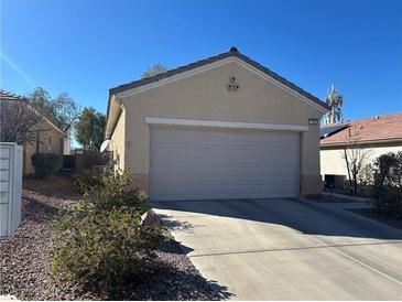 Charming single-story home featuring an attached two-car garage and low-maintenance landscaping at 1395 Kapelle St, Henderson, NV 89052