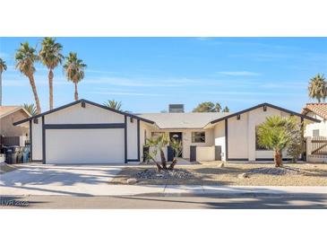 Charming single-story home featuring a well-manicured front yard and two-car garage at 2415 La Estrella St, Henderson, NV 89014