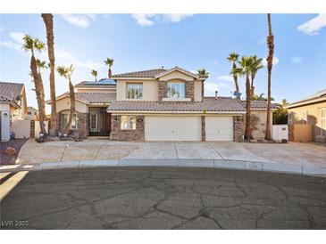 Inviting two-story home with desert landscaping, a three-car garage, and a tile roof at 255 El Camino Verde St, Henderson, NV 89074