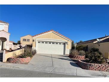 Charming single-story home featuring a two-car garage and desert landscaping at 2694 Hillgrass Rd, Las Vegas, NV 89123