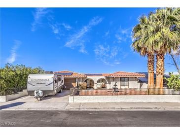 Charming single-story home featuring desert landscaping, a fountain, and an RV parked in the driveway at 3163 High View Dr, Henderson, NV 89014