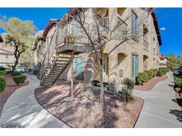 Exterior view of building with walkways, stairs, and tidy landscaping at 3360 Cactus Shadow St # 102, Las Vegas, NV 89129