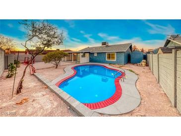 A private backyard featuring a refreshing in-ground pool surrounded by ample space for outdoor enjoyment at 402 Bell Ave, Henderson, NV 89015