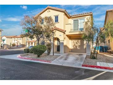 Two-story home featuring neutral siding, two-car garage, balcony, and low-maintenance landscaping at 4228 Hickman Ct, Las Vegas, NV 89129