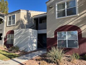 Exterior of two-story apartment building features pedestrian walkways, desert landscaping and architectural detail at 5055 W Hacienda Ave # 1028, Las Vegas, NV 89118