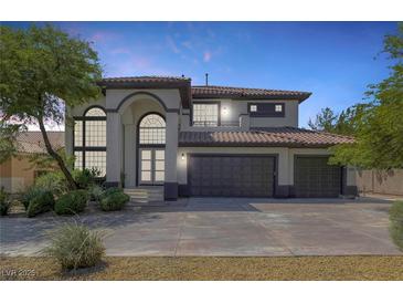 Gorgeous two-story home boasts a three-car garage and a beautifully landscaped front yard at 5271 Villa Vecchio Ct, Las Vegas, NV 89141