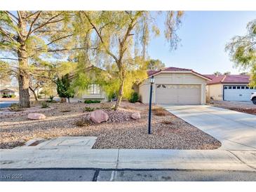 Charming single-story home featuring a two car garage and low maintenance desert landscaping at 5601 Cavalier Cir, Las Vegas, NV 89130