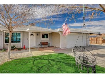 Charming single-story home with well-manicured lawn, covered porch, and cozy patio seating at 604 Canyon Rd, Henderson, NV 89002