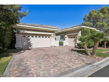 Charming single-story home featuring a brick driveway and manicured landscaping at 613 Pinnacle Heights Ln, Las Vegas, NV 89144