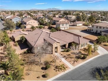 Expansive single-story home featuring desert landscaping, tile roof, and proximity to mountains in a bright, sunny locale at 7860 Thunder Echo St, Las Vegas, NV 89131