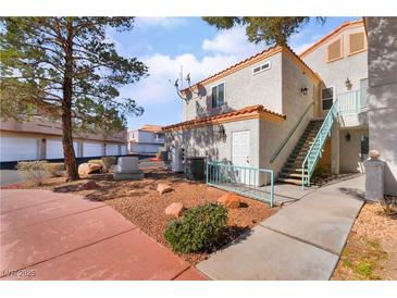 Charming two-story condo featuring well-maintained landscaping and private entry stairs at 8452 Boseck Dr # 285, Las Vegas, NV 89145