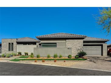 Modern single-story home featuring a manicured front yard and a three-car garage at 11296 Villa Bellagio Dr, Las Vegas, NV 89141