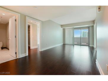 Spacious bedroom with hardwood floors and balcony access showcases city views at 2700 Las Vegas Blvd # 1604, Las Vegas, NV 89109