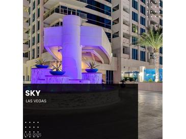 Striking condo building exterior with a circular water feature and vibrant blue architectural lighting at 2700 Las Vegas Blvd # 1604, Las Vegas, NV 89109