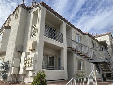 Three-story apartment building with a stucco exterior and metal balconies at 3318 N Decatur Blvd # 2057, Las Vegas, NV 89130