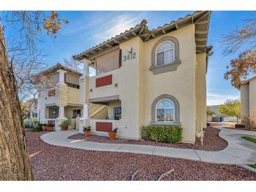 Charming condo with tile roof, arched windows, and covered walkway leading to the building at 3412 Winterhaven St # 101, Las Vegas, NV 89108