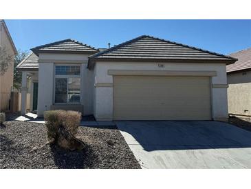 Charming single-story home featuring a two-car garage, low-maintenance landscaping, and a well-maintained front yard at 3941 Yellow Mandarin Ave, North Las Vegas, NV 89081