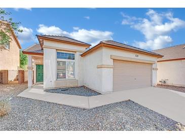 Charming single-story home featuring a two-car garage and well-maintained front yard landscaping at 3941 Yellow Mandarin Ave, North Las Vegas, NV 89081