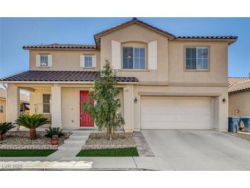 Two-story home featuring a red front door, desert landscaping, and an attached two car garage at 5827 Delonee Skies Ave, Las Vegas, NV 89131