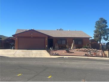 Charming single-story home with a two-car garage and desert landscaping at 706 Morrocco Dr, Henderson, NV 89002