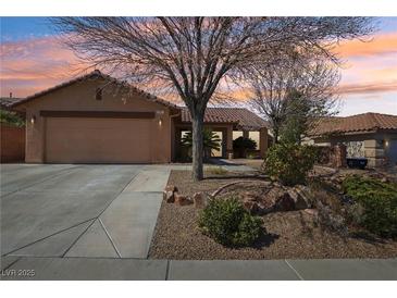 Single level home featuring a two-car garage, low maintenance landscaping, and tile roof at 1011 Amber Gate St, Henderson, NV 89002