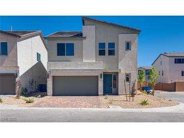 Charming two-story home with a two-car garage and a well-manicured front yard, perfect for suburban living at 10246 Bloom Quick Ct, Las Vegas, NV 89141