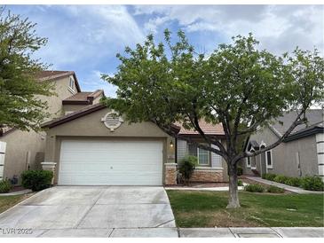 Charming single-Gathering home featuring a two-car garage, well-maintained lawn, and mature landscaping at 10321 Birch Bluff Ln, Las Vegas, NV 89145