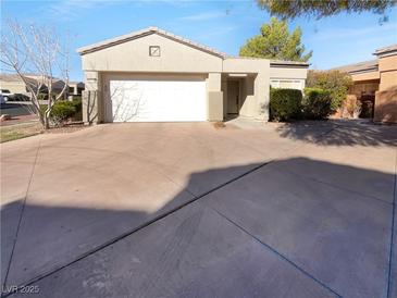 Single-story home featuring a two-car garage and neutral color scheme at 10524 India Hawthorn Ave, Las Vegas, NV 89144