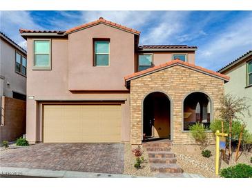 Charming two-story home featuring a brick facade entrance and attached two-car garage at 11572 Salt Creek Ave, Las Vegas, NV 89138