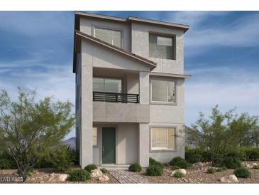 Modern three-story home with gray stucco exterior, small balcony, and minimalist landscaping at 1513 Bat Hawk St, Las Vegas, NV 89144