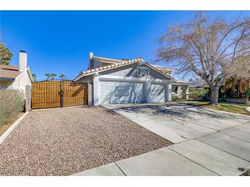 Charming two-story home with a spacious driveway and beautiful desert landscaping and a basketball hoop on the garage at 2209 Piccolo Way, Las Vegas, NV 89146