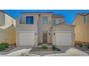 Charming two-story home featuring a tile roof, balcony and a two-car garage at 5861 Secret Island Dr, Las Vegas, NV 89139