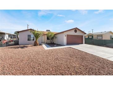 Charming single-story home with desert landscaping, paved driveway, and attached two-car garage at 1105 Pawnee Ln, Henderson, NV 89015