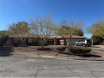 Charming single-story home with a well-manicured front yard, mature trees and a private driveway at 2246 Almart Cir, Henderson, NV 89014