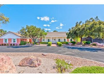 Charming single-story home featuring a well-manicured front yard and inviting entrance at 2825 E Hacienda Ave, Las Vegas, NV 89120