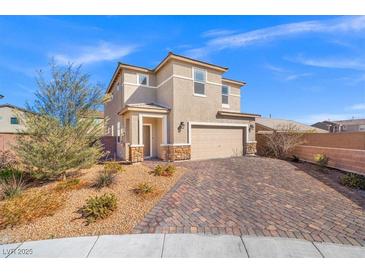 Charming two-story home with desert landscaping and a brick driveway at 430 Shimmering Sands Ave, North Las Vegas, NV 89031