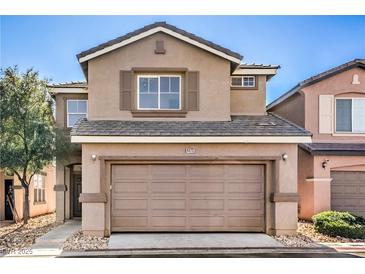 Inviting two-story home featuring an attached two-car garage and neutral stucco exterior, creating a warm curb appeal at 4473 Oberlander Ave, North Las Vegas, NV 89031