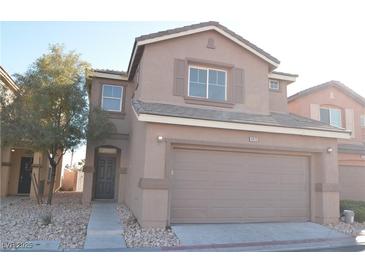 Inviting two-story home with a large front-facing two car garage and low maintenance desert landscaping at 4473 Oberlander Ave, North Las Vegas, NV 89031