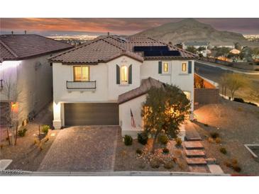 Charming two-story home with desert landscaping and a tile roof under a beautiful sunset sky at 4504 Eagle Nest Peak St, Las Vegas, NV 89129