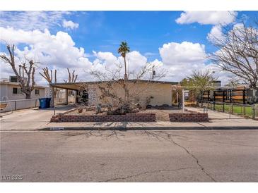 Charming single-story home featuring desert landscaping, a carport, and a welcoming facade at 5125 Hallet Dr, Las Vegas, NV 89122