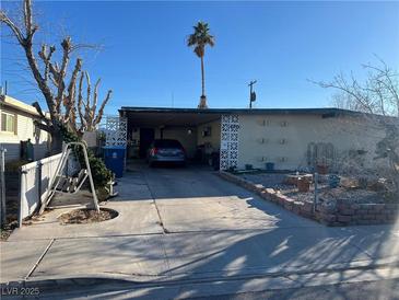 Modest single story home with covered carport and desert landscaping in front yard at 5125 Hallet Dr, Las Vegas, NV 89122