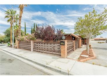 Charming single-story home featuring a unique woven fence, mature landscaping, and a well-maintained exterior at 5323 Taravilla Cir, Las Vegas, NV 89146