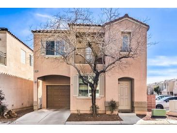 Charming two-story home with a tan exterior, attached garage, and lovely curb appeal at 6687 Higger Tor Ave, Las Vegas, NV 89139