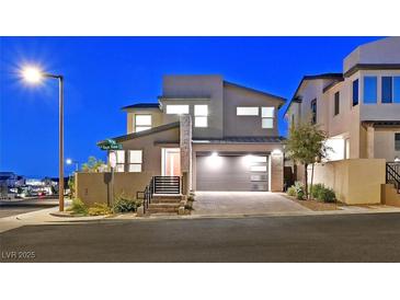 Contemporary two-story home featuring a two-car garage and modern architectural details at twilight at 796 Keys View Ave, Las Vegas, NV 89138