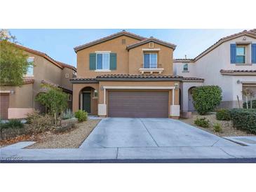 Two-story home featuring a 2-car garage, desert landscaping, and a charming, covered front entryway at 10139 Palazzo Marcelli Ct, Las Vegas, NV 89147